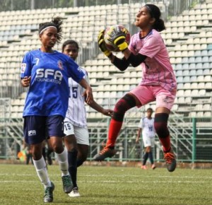 Next Sports Academy goalkeeper Diya Patel (right) leaps to collect the ball to deny Amma FC attacker Punam Kumari from getting to the ball during their WIFA Women’s Football League .