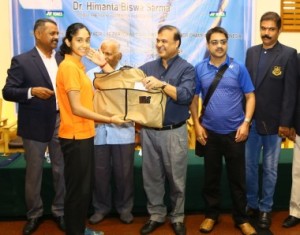 BAI President during the send off Ceremony for the Junior National Team in Bangalore handing over the Indian Blazer to the players .