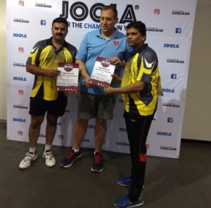 Dr.Nitin Toshniwal( R) and Premjit Rananavare from India receive their Cosolation Men's 45+ Doubles prize. 