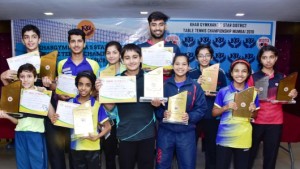 Men’s singles champ  Ravindra Kotian (centre) and Vidhi Shah (women’s champ- with specs) with other winners of the Khar  Gymkhana-5-Star Mumbai Suburban District table tennis championships . 