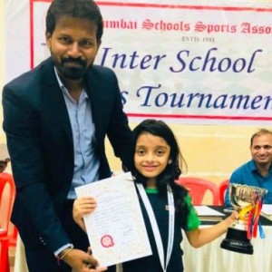 Anaishaa Nahar, who emerged victorious in the Girl’s U-8 category of the MSSA Inter-schools chess championship, receives the winners’ trophy and certificate from FM Balaji Guttula, Chairman, MCDCA .