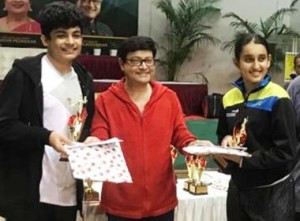 Harsh Sharma (left) and Siya Singh pose with their mixed doubles winners’ trophies film actor Sachin Pilgaonkar (centre) 