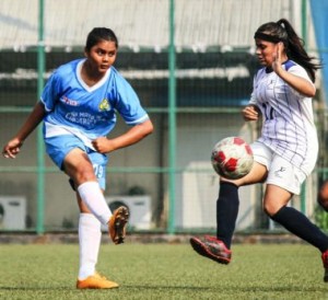 Pacangan striker Sharvari Donkar takes a shot as Next Sports Academy defender takes evasive action during their WIFA Women’s Football League .