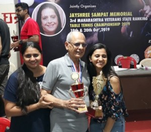 Pinakin Sampat the Sponsor of this tournament poses with his daughters proudly displaying his trophy .