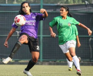 SP Football Academy defender Crystal Blakely (left) clears the ball as a Kenkre FC midfielder Yashmita Mahatre charges in for a tackle during their WIFA Women’s Football League on Sunday.