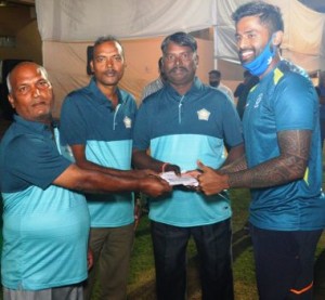 Indian cricketer Suryakumar Yadav( Ext . R)  who won the Best batsman of the Police Invitation Shield Cricket tournament award presents his cash award to the groundsmen of the Mumbai Police Gymkhana.