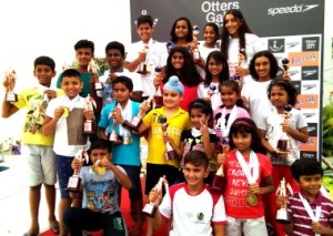 Winners of the 32nd Otters Open Swimming and Diving Championships pose for a photo with their medals. 